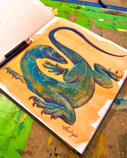 Colorful lizard illustration on a notebook cover with a textured background